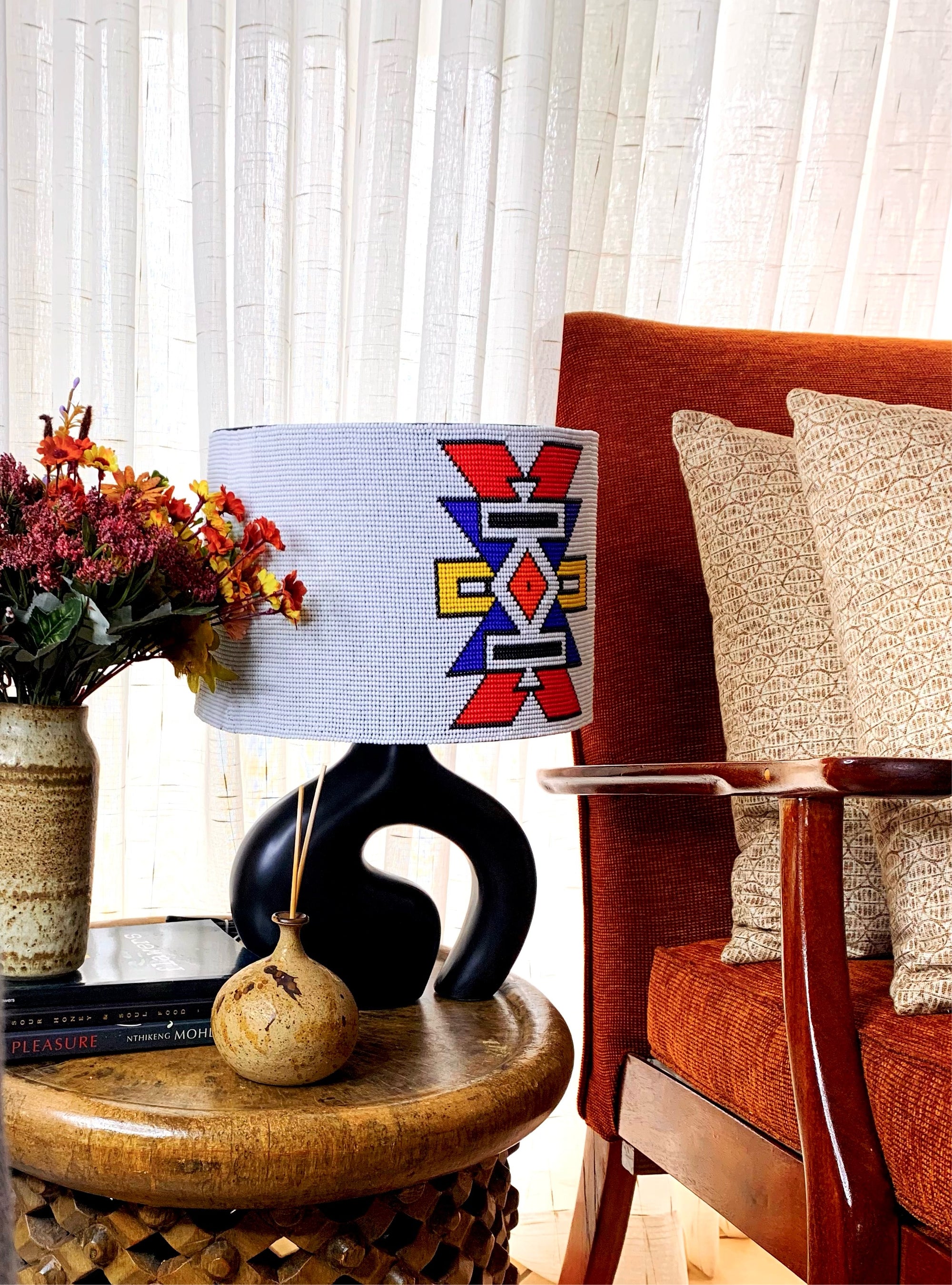 Ndebele beaded lampshade in white with a dash of color