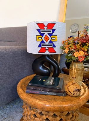 Ndebele beaded lampshade in white with a dash of color