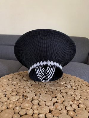 Black hat with white tassels and U-shaped tassels